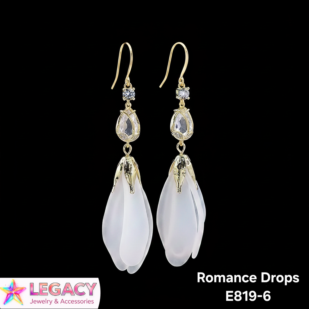 A pair of gold-tone drop earrings with clear rhinestone accents and large, teardrop-shaped milky white beads, labeled 'Romance Drops E819-6' on a black background with a Legacy Jewelry & Accessories logo.