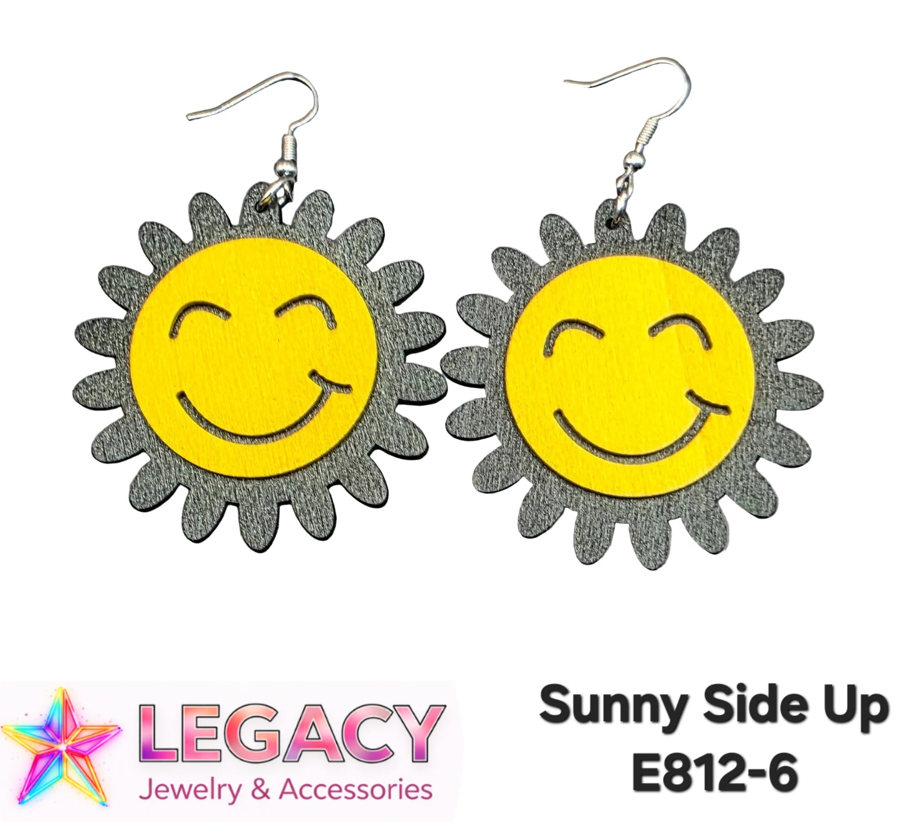 A pair of dangle earrings shaped like smiling suns, with bright yellow circular faces and textured dark gray petal-like borders, shown on a white background. The text 'Sunny Side Up E812-6' appears at the bottom right, and a 'Legacy Jewelry & Accessories' logo appears at the bottom left.